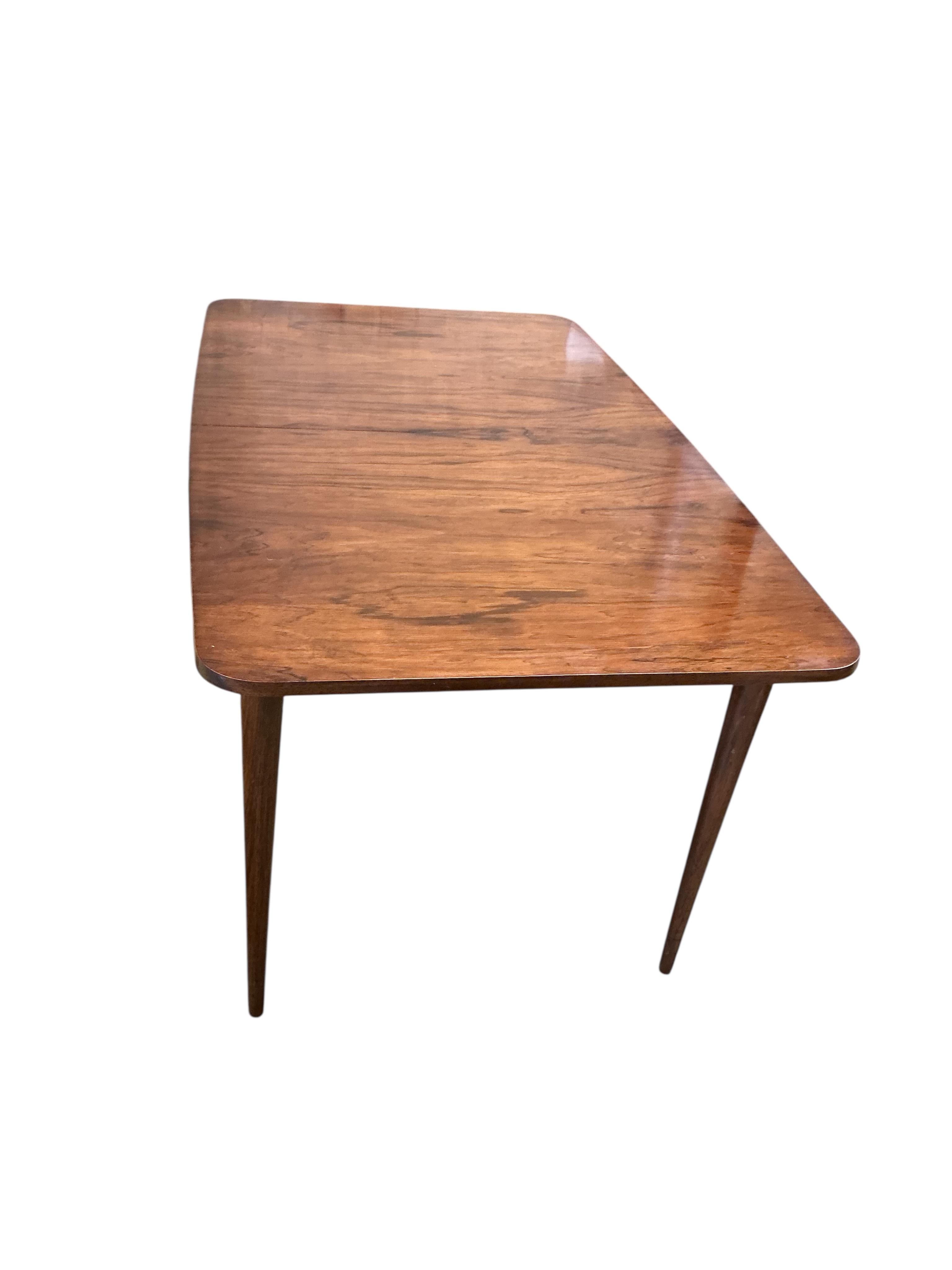 A mid century Archie Shine Indian rosewood extending dining table, width 144cm, depth 84cm, height 72cm and six upholstered chairs, two with arms